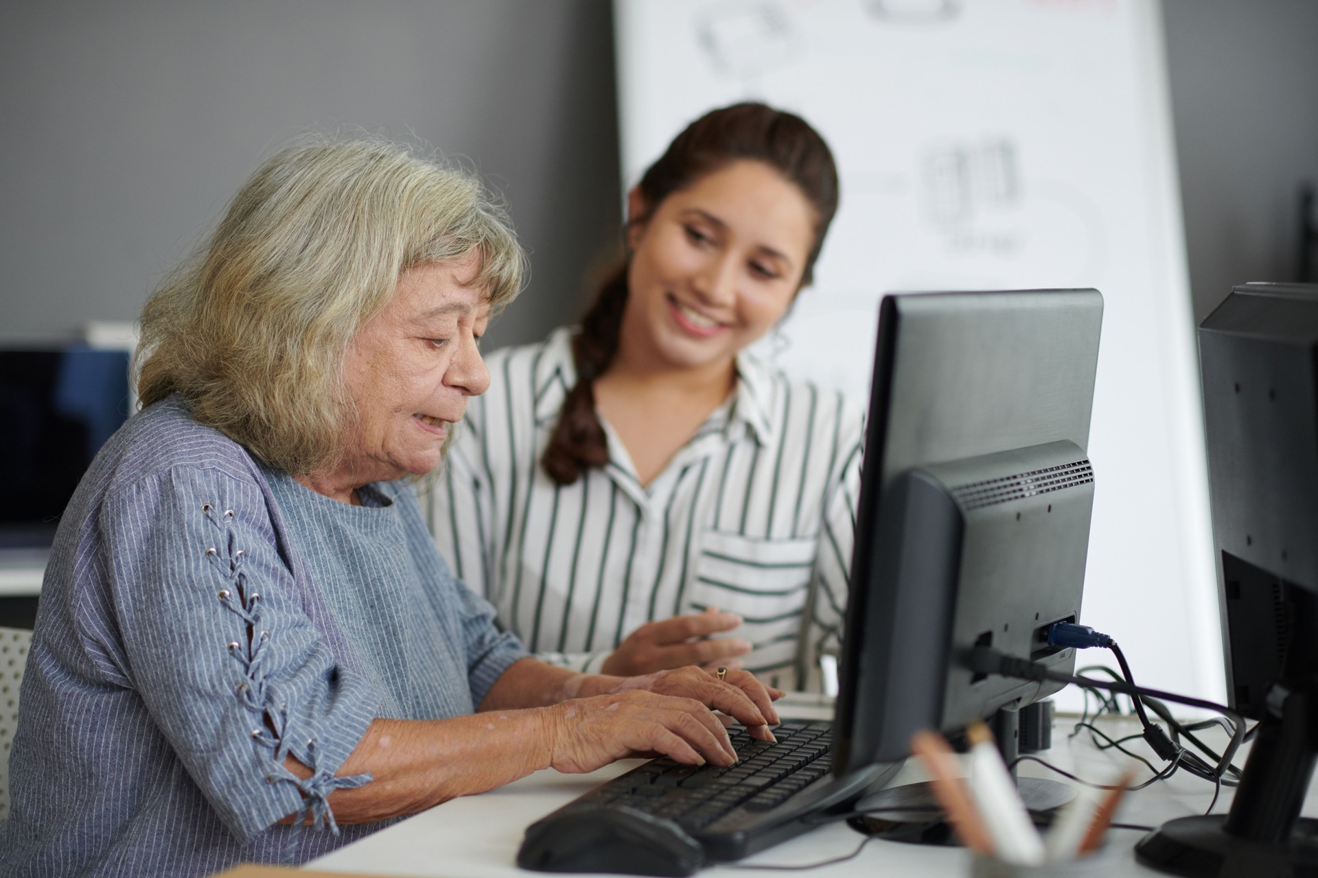 Elderly Woman Typing on Computer